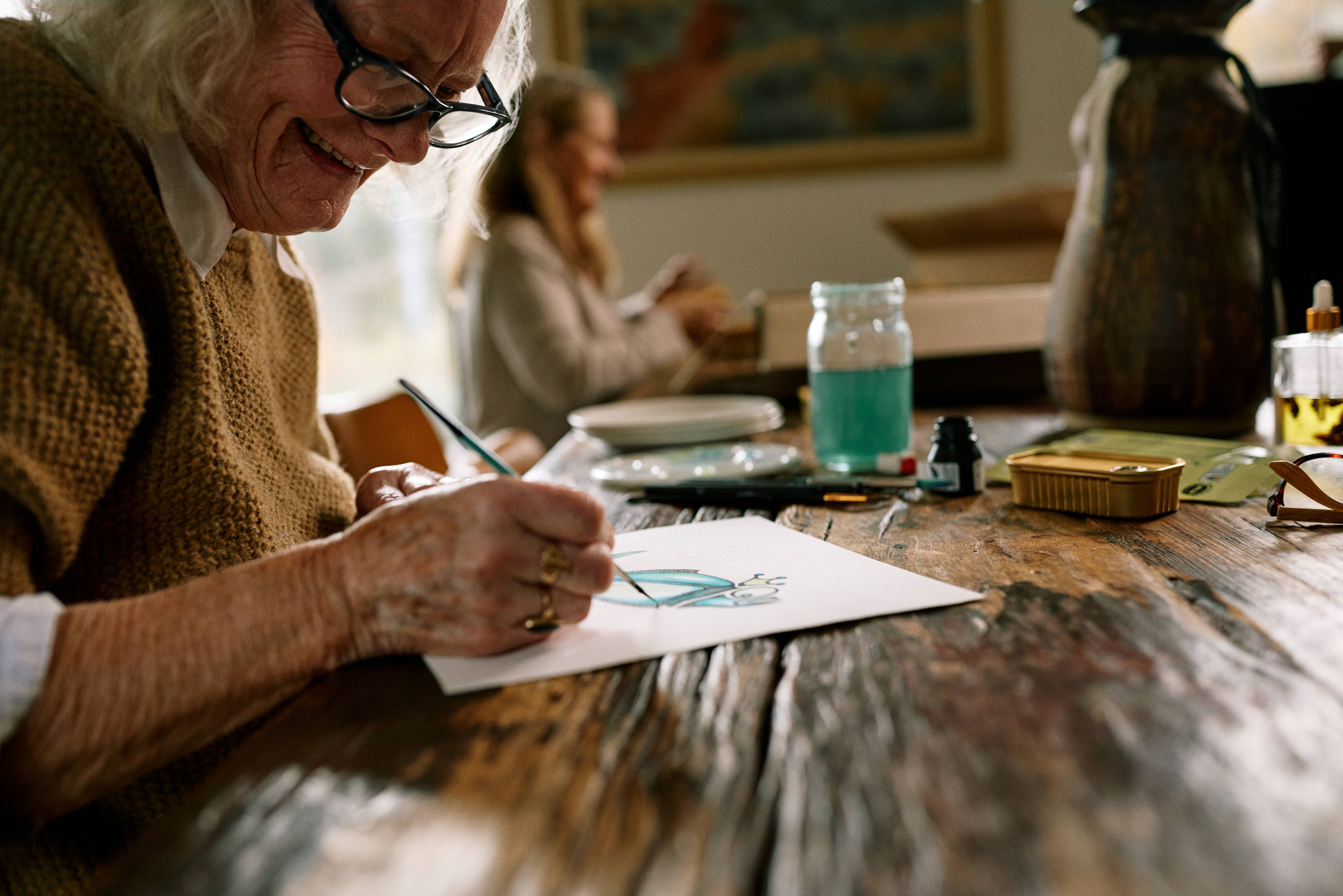 Older person painting artwork