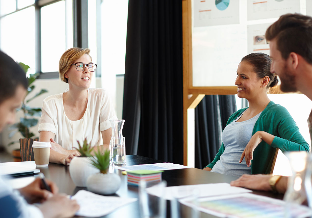 People gathered around a table in discussion